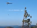 A wildland firefighting crew rappels out of a helicopter to battle a fire reported by ham radio. [Bobby Debevec, W6IWN, photo via YouTube]